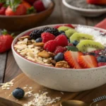 Strawberry raspberry acai bowl with fresh toppings on a wooden table